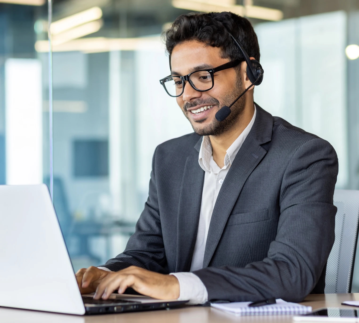 a man wearing a headset and using a laptop